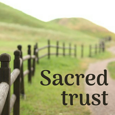 a path and fence with the words "Sacred trust"