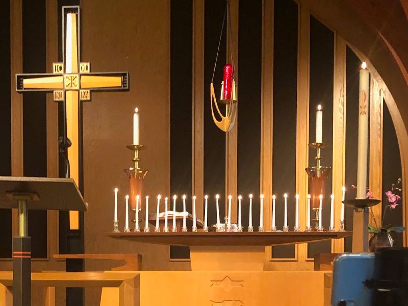 altar with row of lit candles