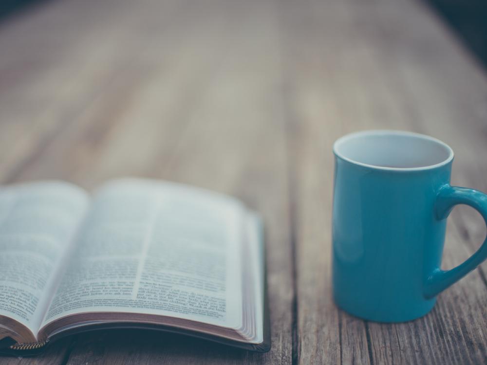 open bible with coffee